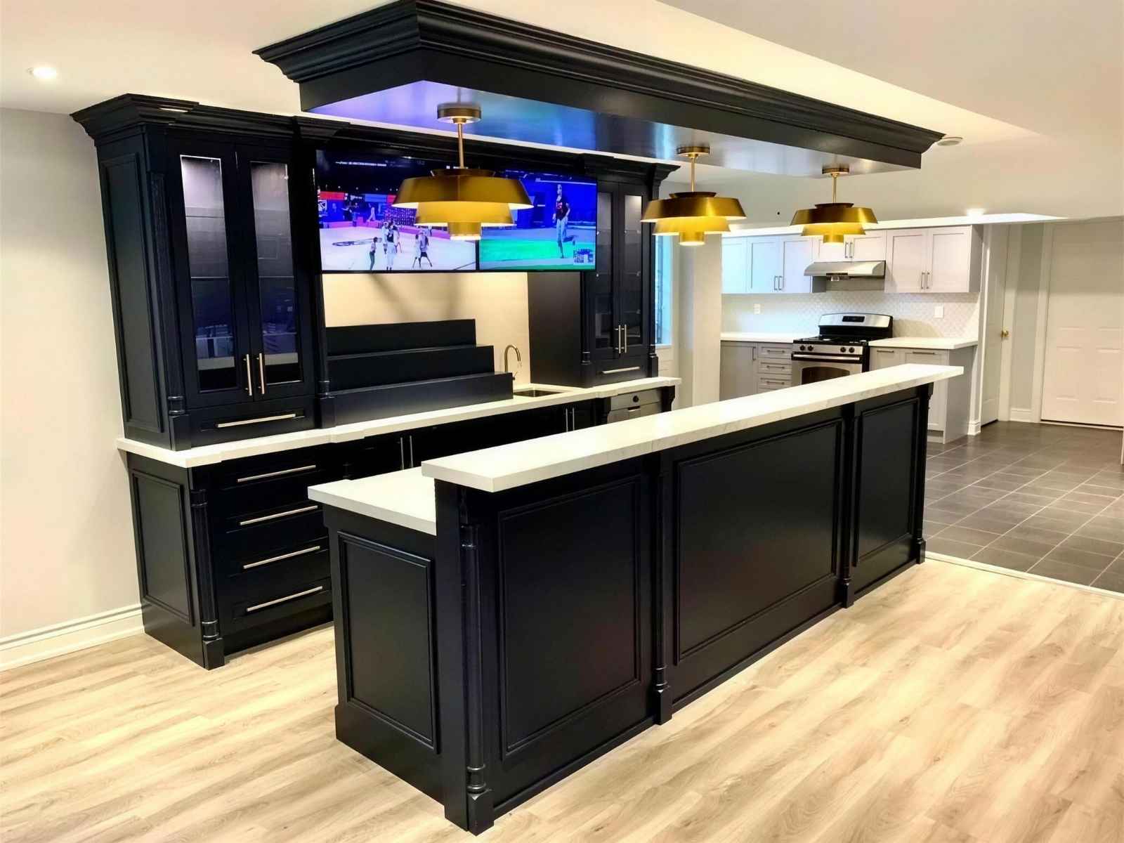 Finished legal basement renovation with custom bar and media wall